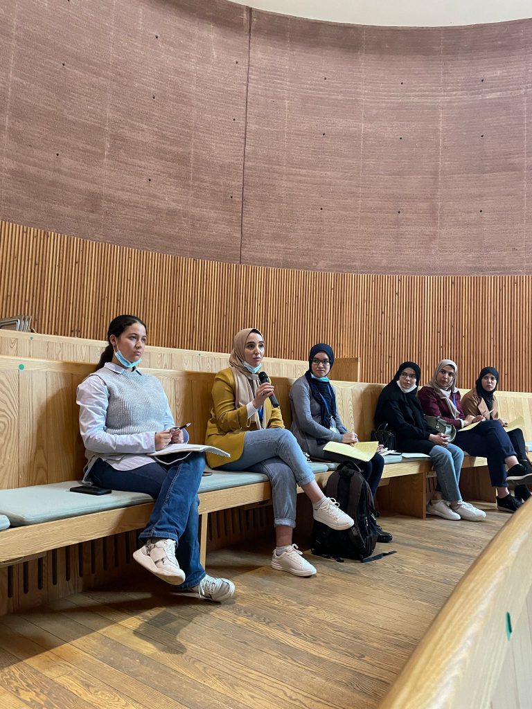 Ikram asks a question in the conference hall 